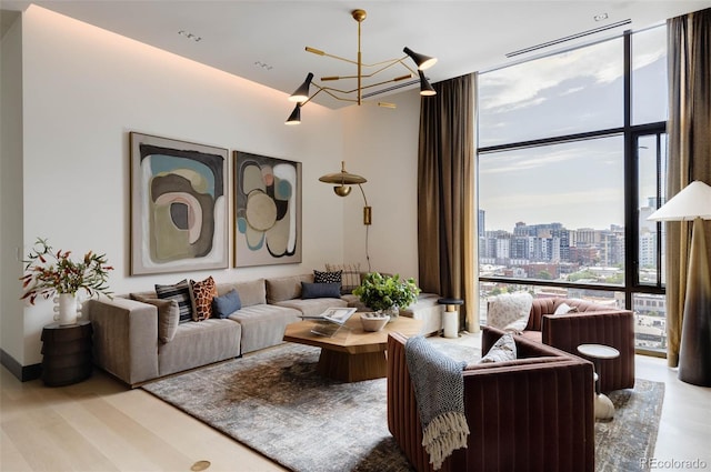 living room with a notable chandelier and a wall of windows