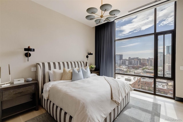 bedroom with an inviting chandelier and a wall of windows