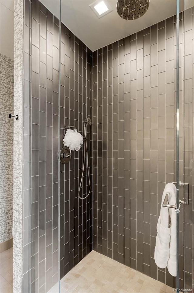 bathroom with tiled shower