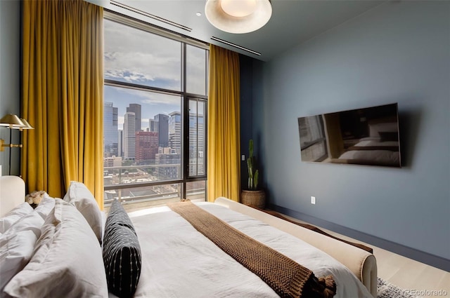 bedroom featuring hardwood / wood-style flooring and floor to ceiling windows