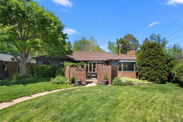 view of front of property with brick siding and a chimney