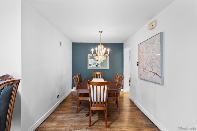 dining space with a chandelier, wood finished floors, and baseboards