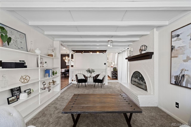 living area featuring carpet flooring, beam ceiling, and a brick fireplace