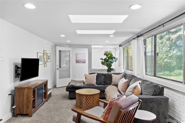 living room with a skylight, recessed lighting, light carpet, and baseboards