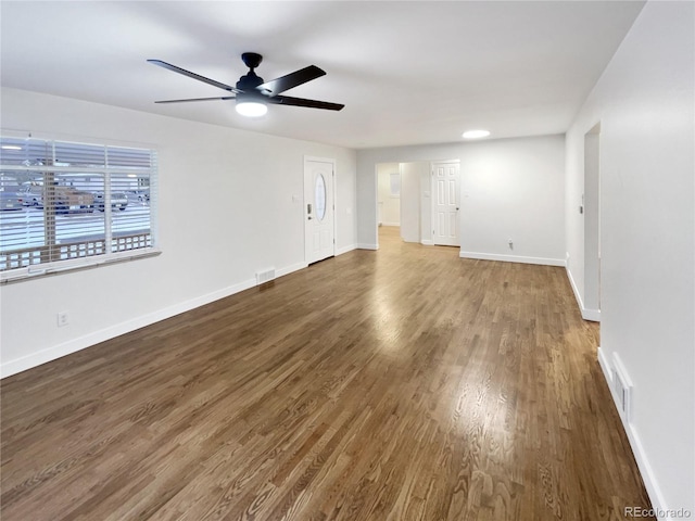 unfurnished room featuring ceiling fan and dark hardwood / wood-style floors