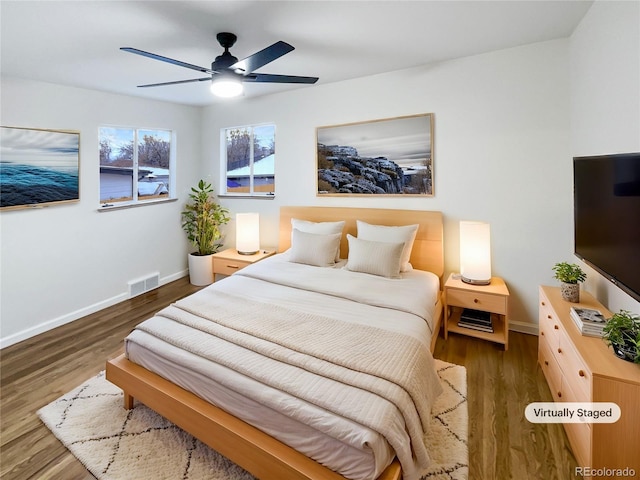 bedroom with ceiling fan and dark wood-type flooring