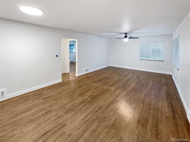 empty room featuring dark hardwood / wood-style floors and ceiling fan