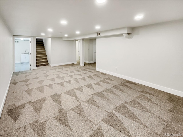 basement featuring light carpet