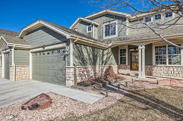 view of front of home with concrete driveway, a garage, and stone siding