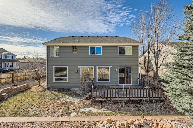 back of property featuring a deck and fence