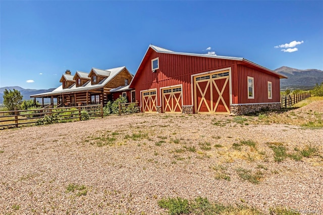 view of outbuilding with a mountain view and a rural view