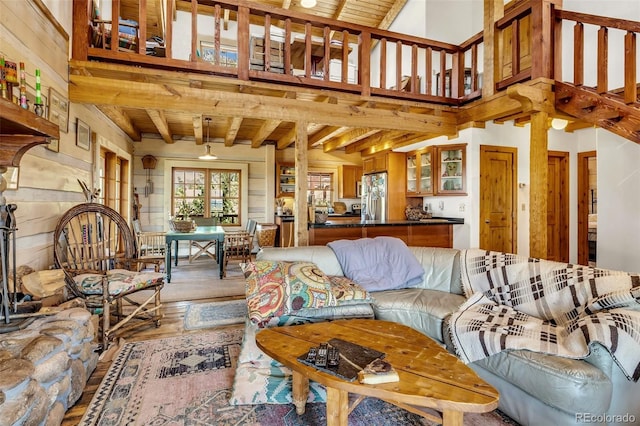 living room featuring hardwood / wood-style floors, wood ceiling, and beam ceiling