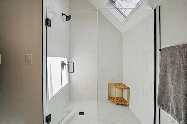 full bathroom featuring a stall shower and a skylight
