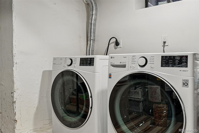 clothes washing area with independent washer and dryer