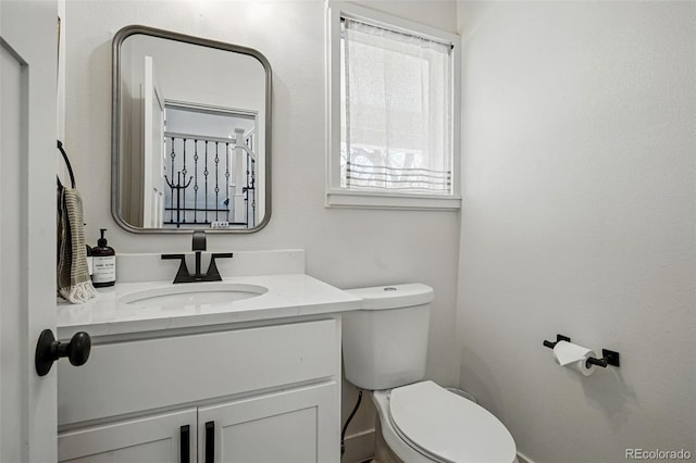 bathroom with toilet and vanity