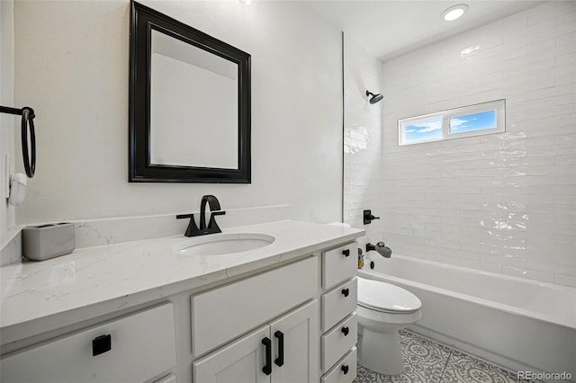 full bathroom featuring toilet, vanity, tile patterned flooring, and  shower combination