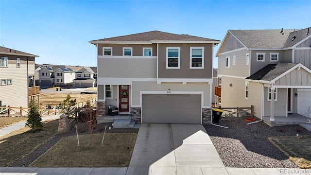 view of front facade with concrete driveway, board and batten siding, fence, a garage, and a residential view