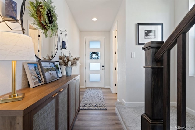 doorway to outside with stairway, baseboards, wood finished floors, and recessed lighting