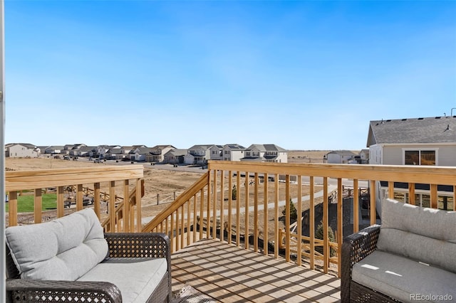 wooden terrace featuring a residential view and an outdoor living space