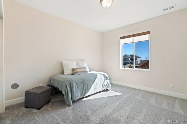 bedroom with carpet, visible vents, and baseboards