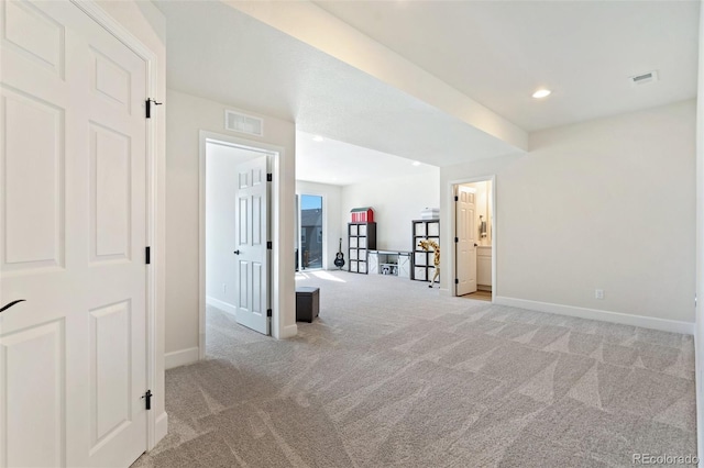 hall featuring light carpet, baseboards, visible vents, and recessed lighting