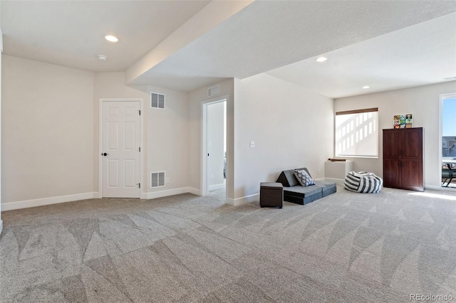 unfurnished room featuring carpet floors, visible vents, and baseboards