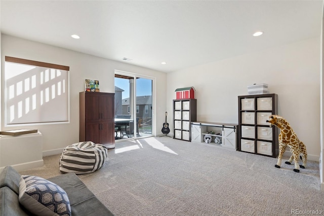 sitting room featuring baseboards, carpet floors, and recessed lighting