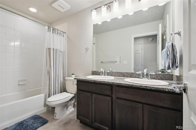 19221 E 65th Ave, Denver, CO 80249 - full bathroom with double vanity, shower / bathtub combination with curtain, and recessed lighting