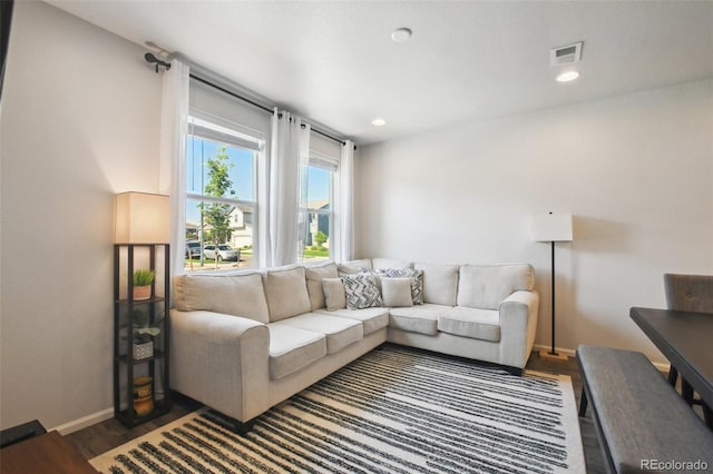 19221 E 65th Ave, Denver, CO 80249 - living room featuring dark wood-style flooring and recessed lighting