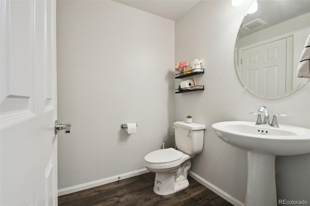 19221 E 65th Ave, Denver, CO 80249 - half bathroom featuring wood finished floors and toilet