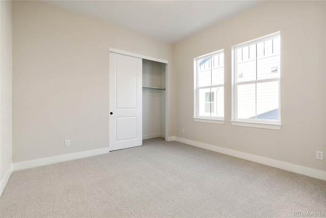 unfurnished bedroom with carpet flooring and a closet