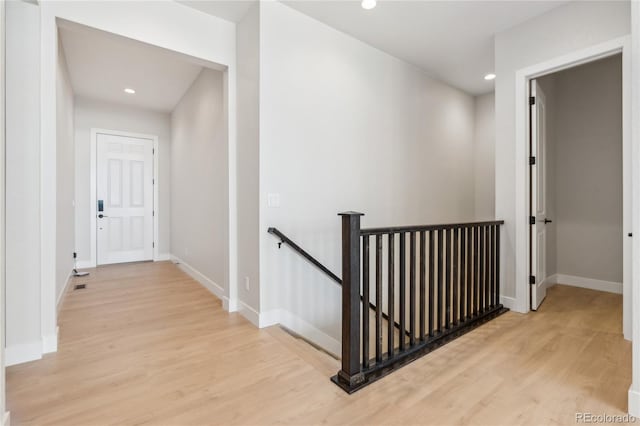 hallway with light hardwood / wood-style flooring