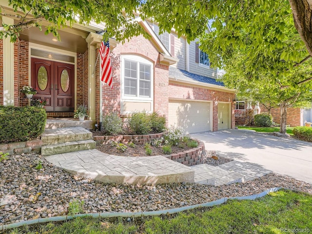 6577 S Waco Way, Aurora, CO 80016 - view of front of property with concrete driveway, brick siding, and an attached garage