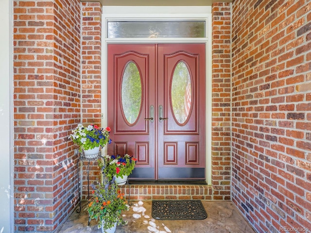 6577 S Waco Way, Aurora, CO 80016 - doorway to property with brick siding