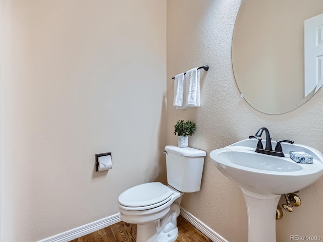 6577 S Waco Way, Aurora, CO 80016 - half bathroom with wood finished floors and toilet