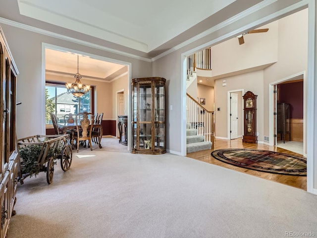 6577 S Waco Way, Aurora, CO 80016 - carpeted foyer featuring a chandelier, stairway, crown molding, and a raised ceiling