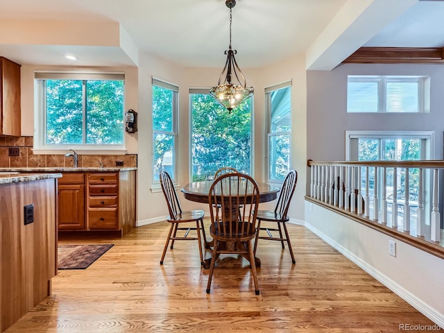 6577 S Waco Way, Aurora, CO 80016 - dining area with light wood-style flooring and healthy amount of natural light