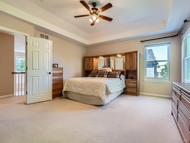 6577 S Waco Way, Aurora, CO 80016 - bedroom featuring light colored carpet, a tray ceiling, and ceiling fan