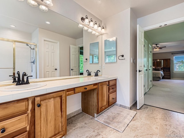 6577 S Waco Way, Aurora, CO 80016 - full bath with double vanity, connected bathroom, ceiling fan, and a stall shower