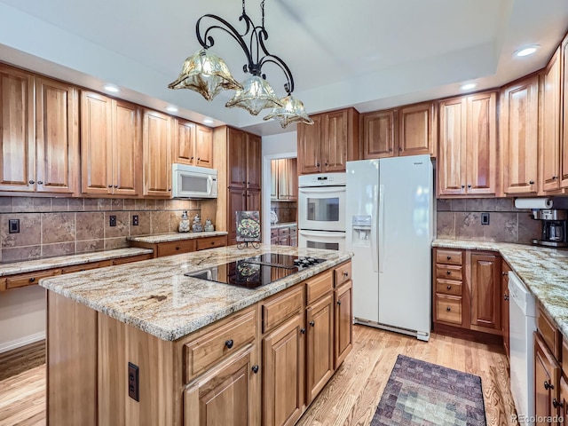 6577 S Waco Way, Aurora, CO 80016 - kitchen featuring white appliances, recessed lighting, tasteful backsplash, and light stone countertops