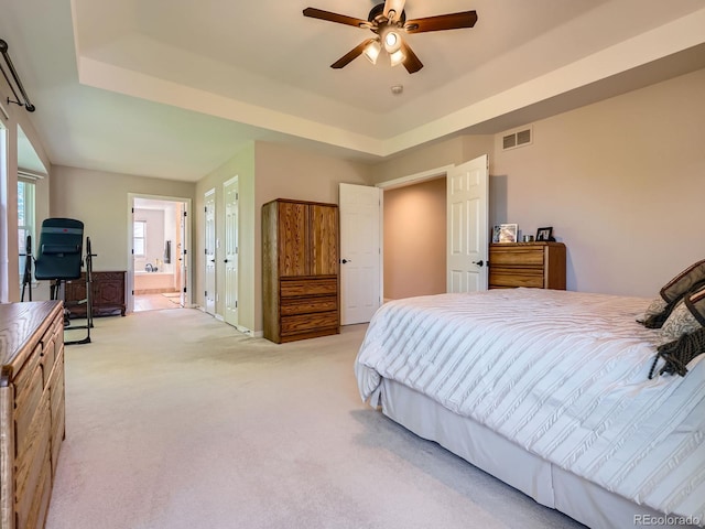 6577 S Waco Way, Aurora, CO 80016 - bedroom featuring light colored carpet, connected bathroom, a raised ceiling, ceiling fan, and a desk