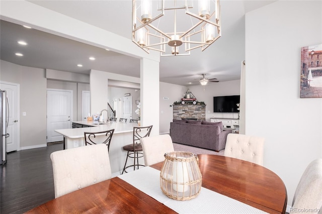 dining room featuring baseboards, dark wood finished floors, a ceiling fan, and recessed lighting