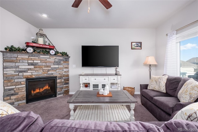 living area with ceiling fan, carpet, a fireplace, and baseboards