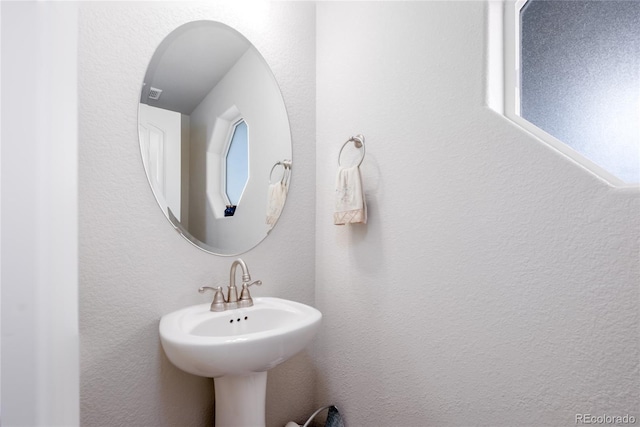 bathroom featuring a textured wall