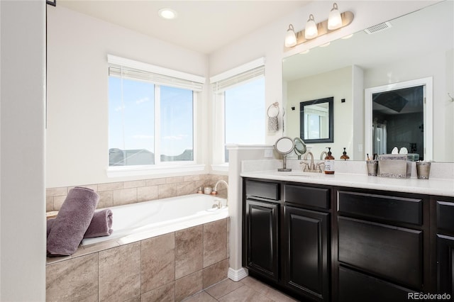 full bath featuring a bath, vanity, tile patterned flooring, and visible vents