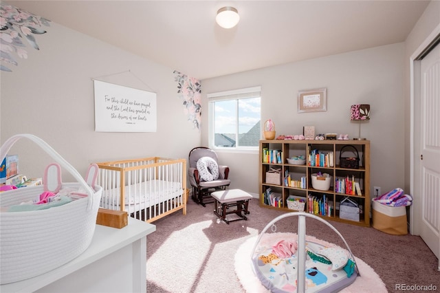 bedroom featuring carpet floors and a nursery area