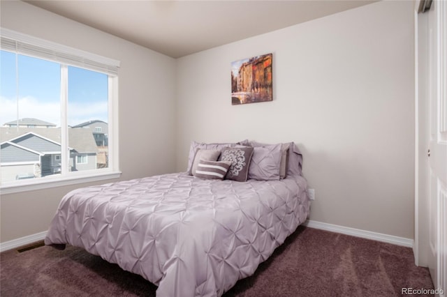 carpeted bedroom featuring visible vents and baseboards