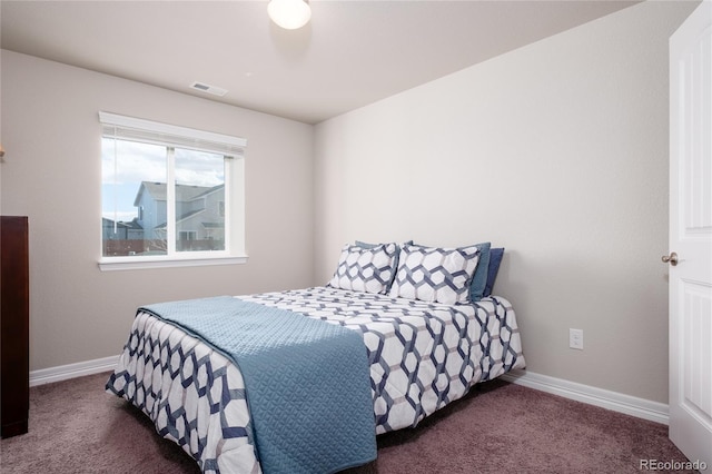 carpeted bedroom featuring visible vents and baseboards