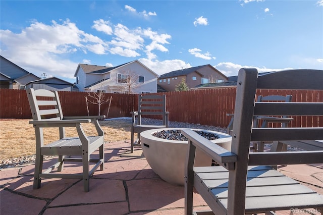 view of patio / terrace featuring a fenced backyard, a residential view, and a fire pit