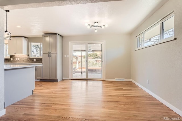 interior space featuring baseboards and light wood-style floors